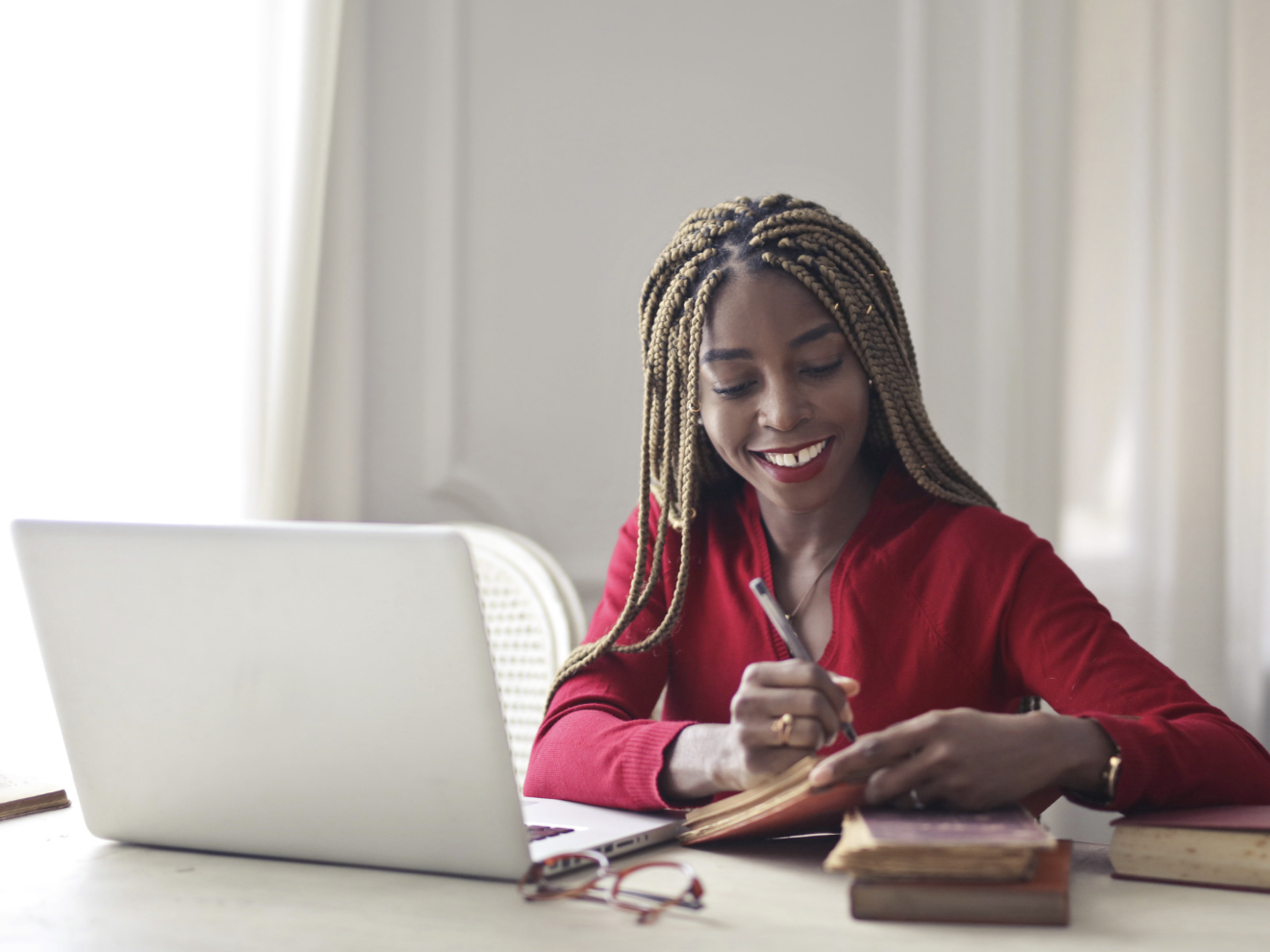 Nosipho, a young Stratum paralegal member, writing notes at her desk